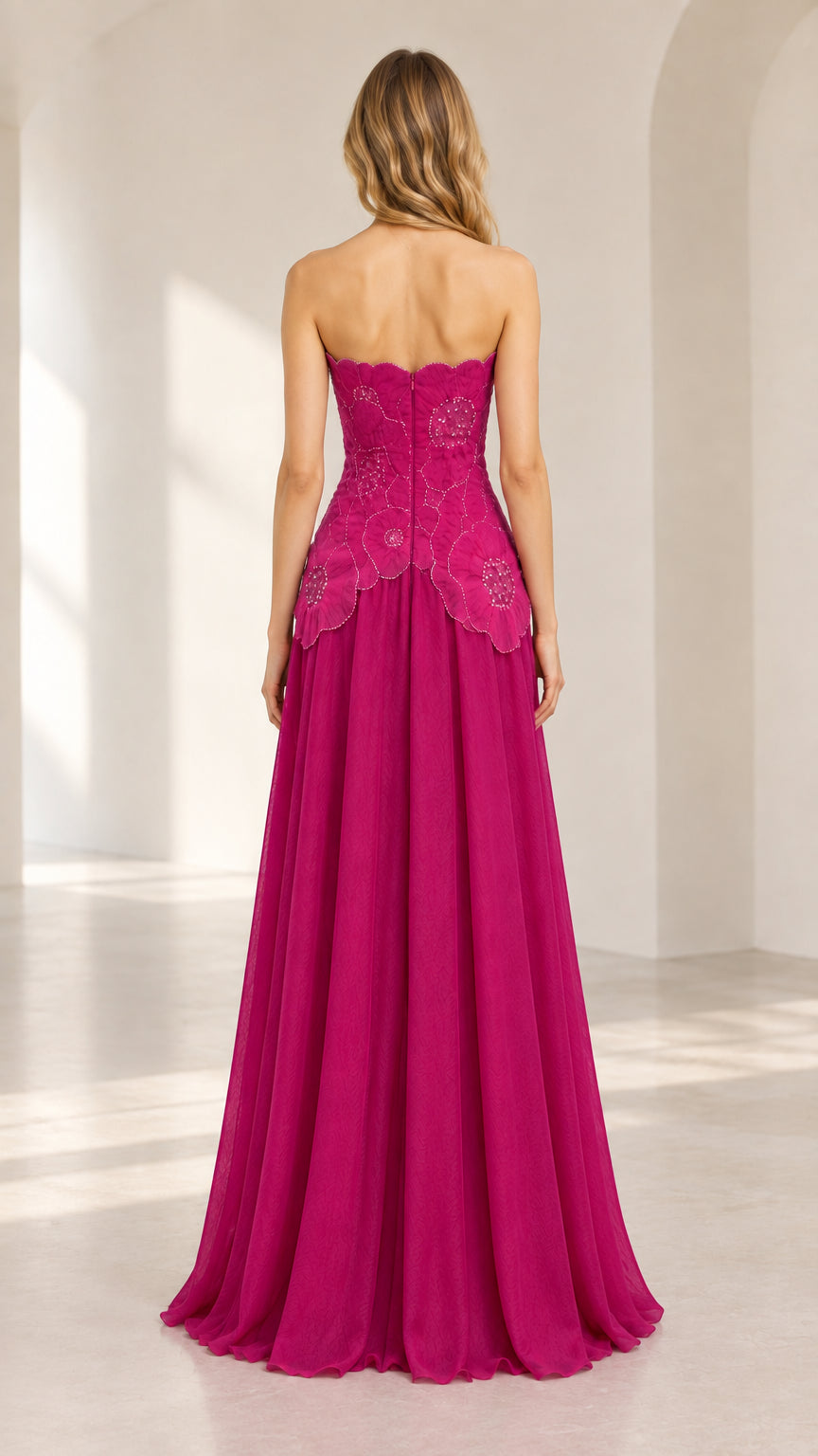 Back view of model wearing magenta strapless floor-length chiffon dress