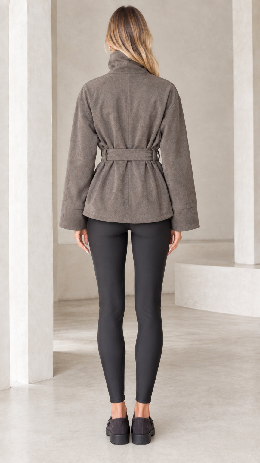 Back view of model wearing taupe belted faux suede jacket with stand collar