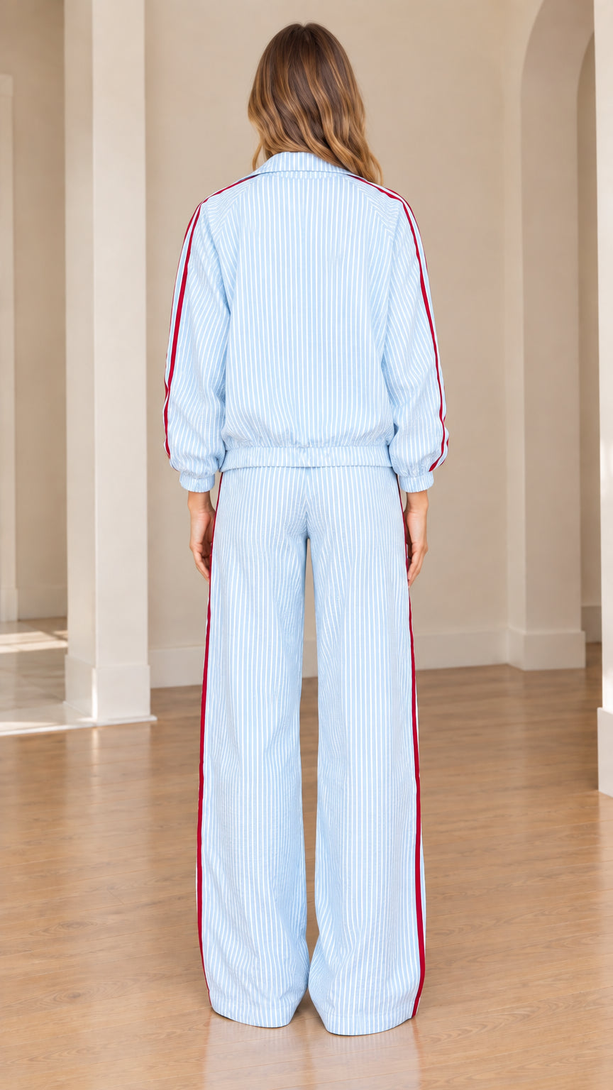 Back view of model in light blue striped tracksuit set with wide-leg pants