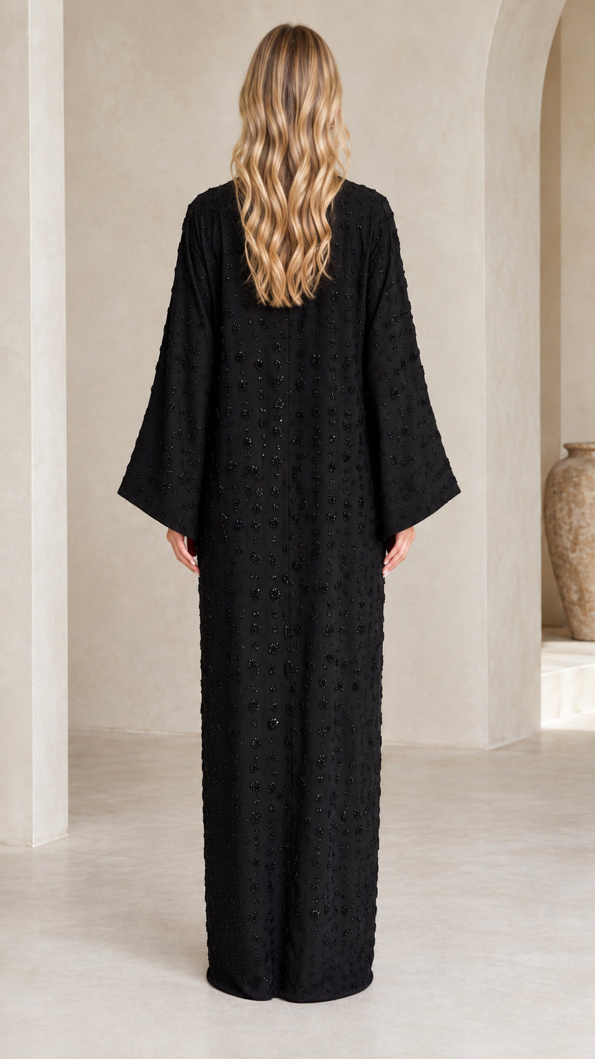 Back view of woman wearing Black flowing embellished abaya dress