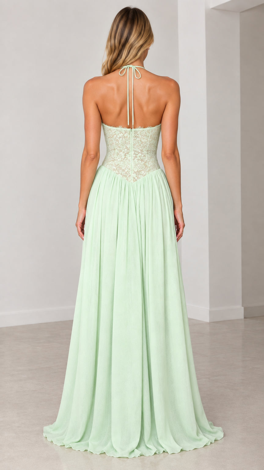 Back view of model showcasing tie halter and open back of mint green dress