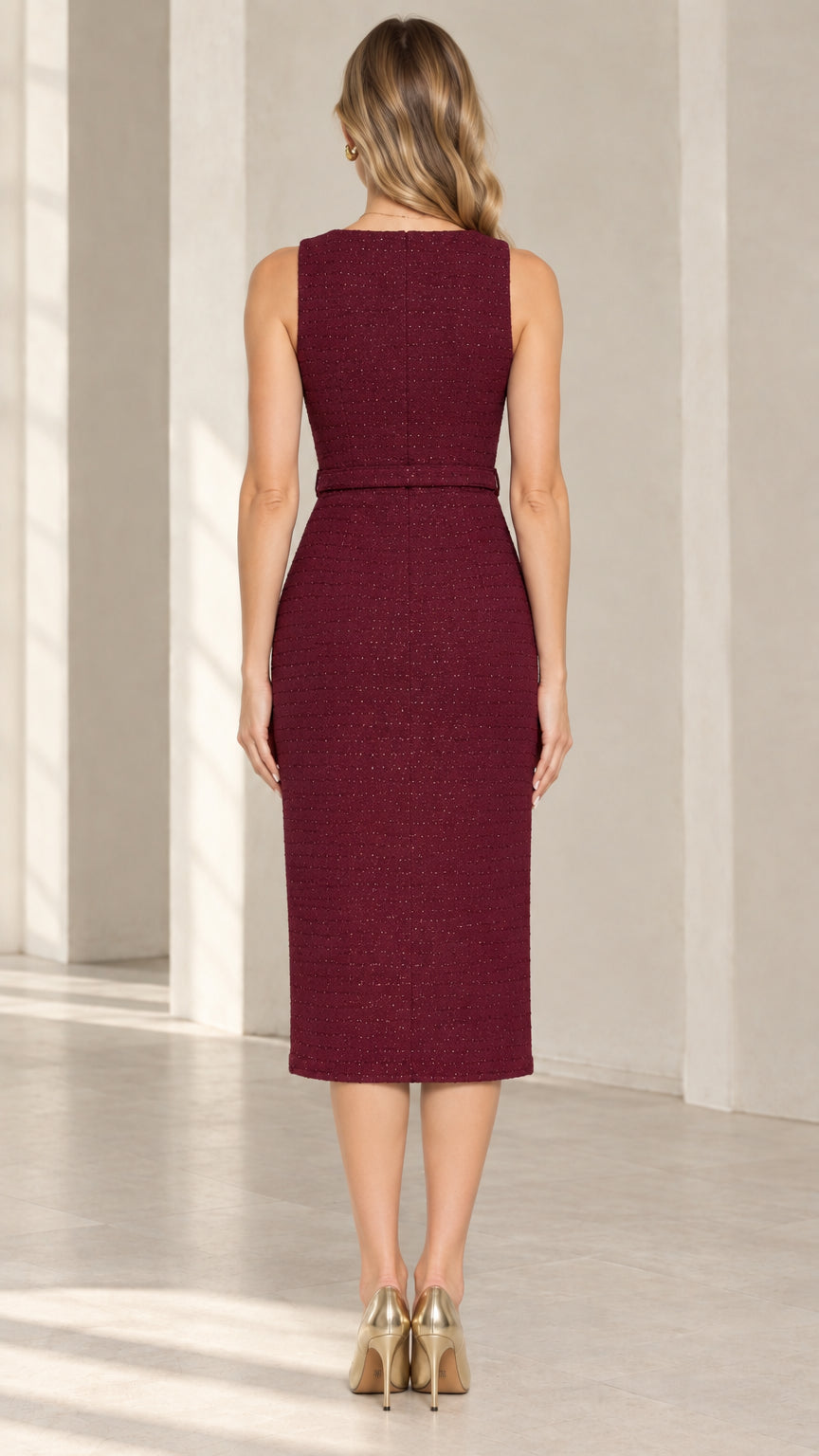Back view of model wearing burgundy midi sheath dress with tailored darts