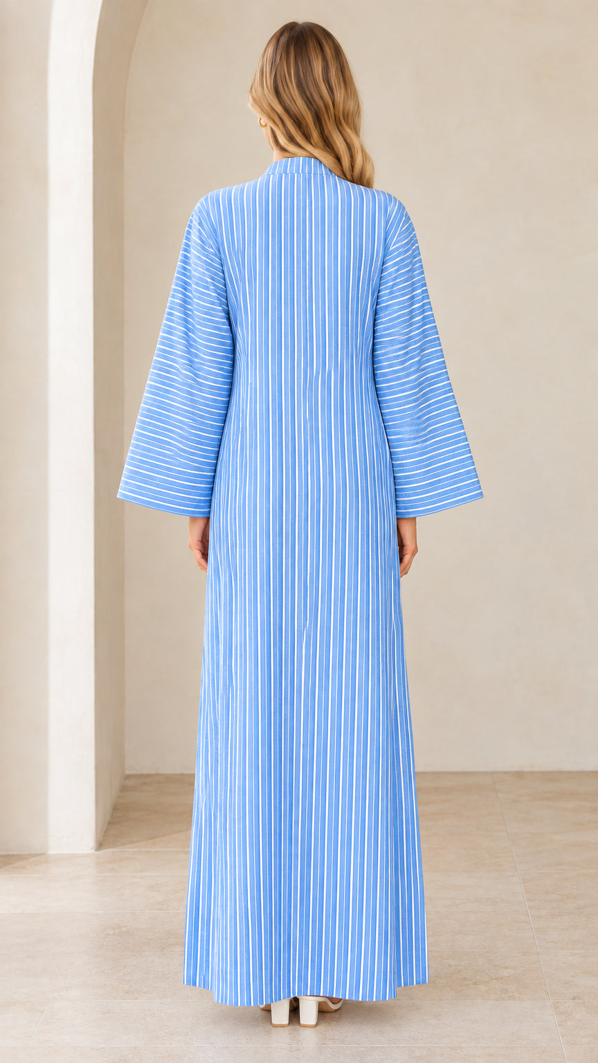 Back view of woman wearing sky blue striped kaftan dress with wide sleeves
