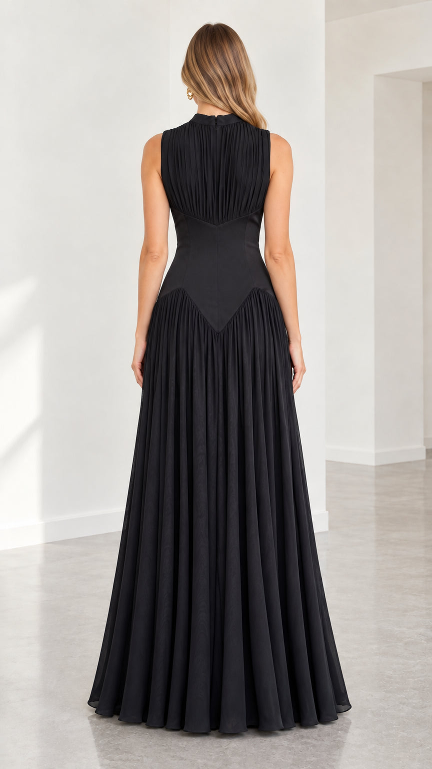 Back view of black high-neck pleated maxi dress showing fitted waist detail