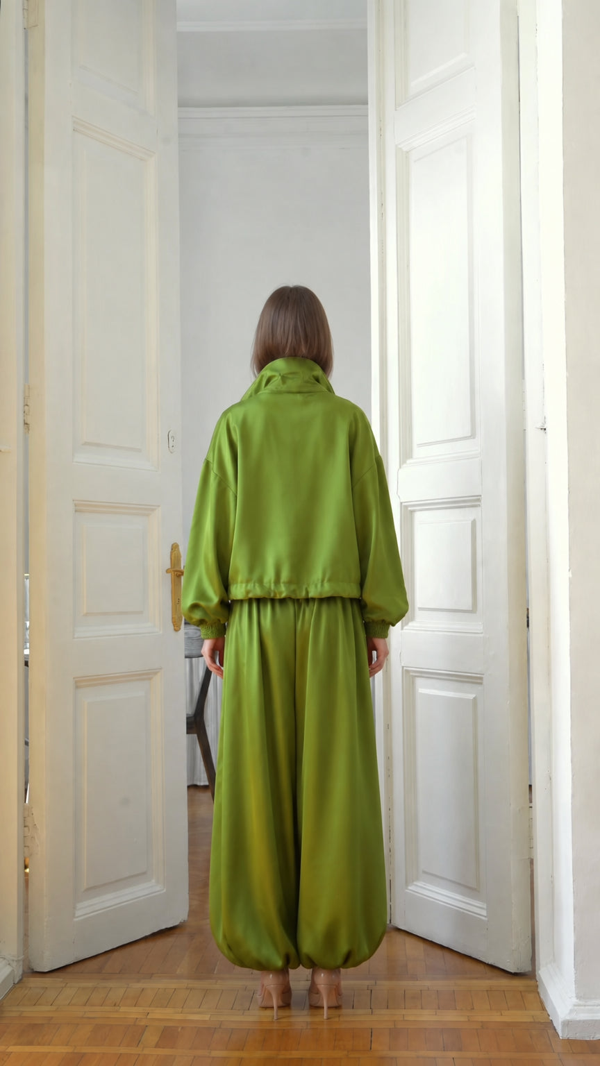 Back view of model wearing lime green balloon pants and relaxed jacket set