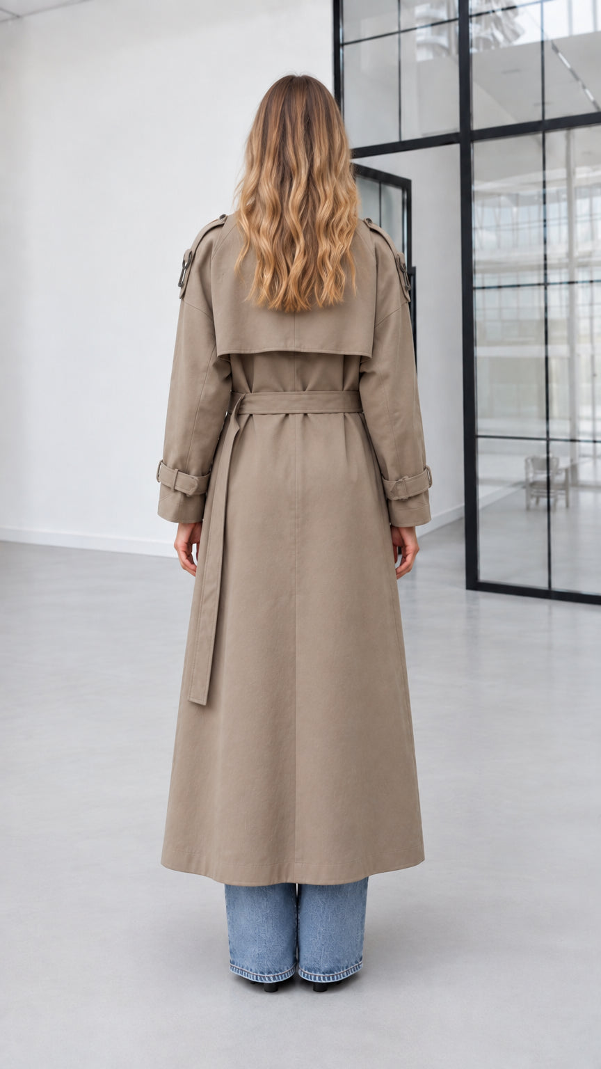 Back view of model wearing khaki long trench coat showing back storm flap and vent