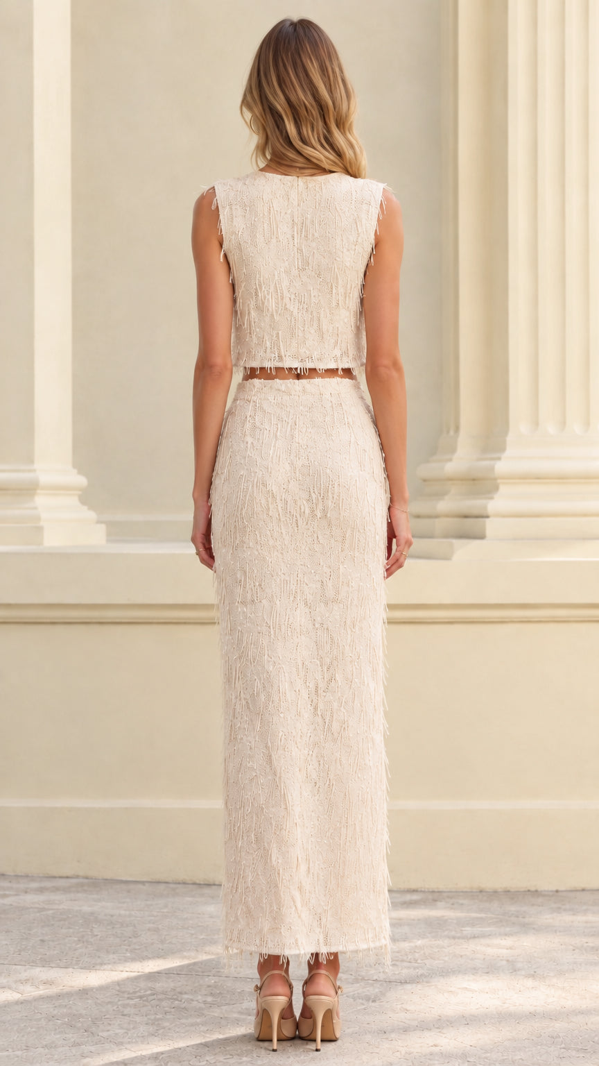 Back view of woman wearing ivory textured fringe two-piece skirt set