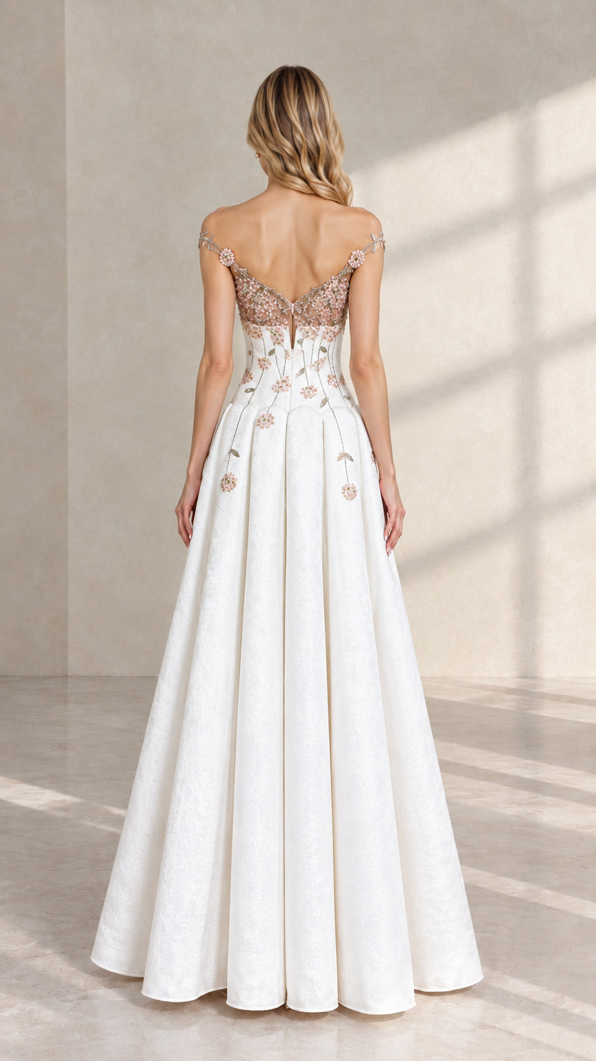 Back view of white formal evening dress featuring illusion V-back and cascading floral embroidery