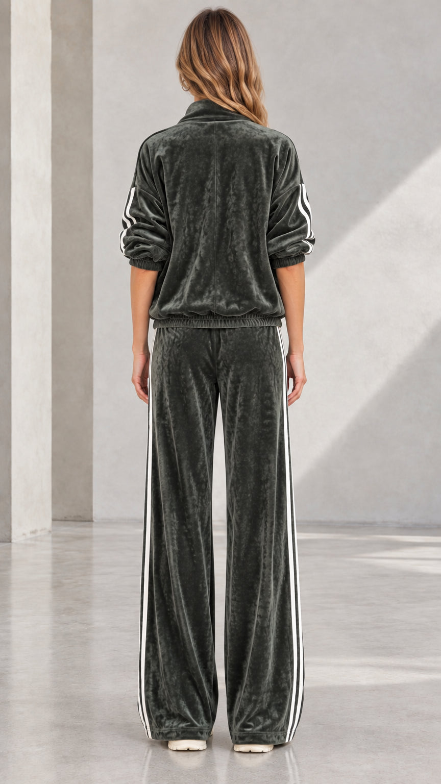 Back view of woman wearing Dark Green velvet tracksuit with wide-leg cut