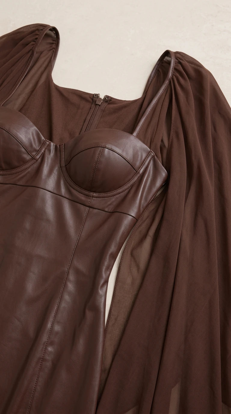 Close-up detail of structured faux leather bustier cups and sheer chiffon shoulder attachment