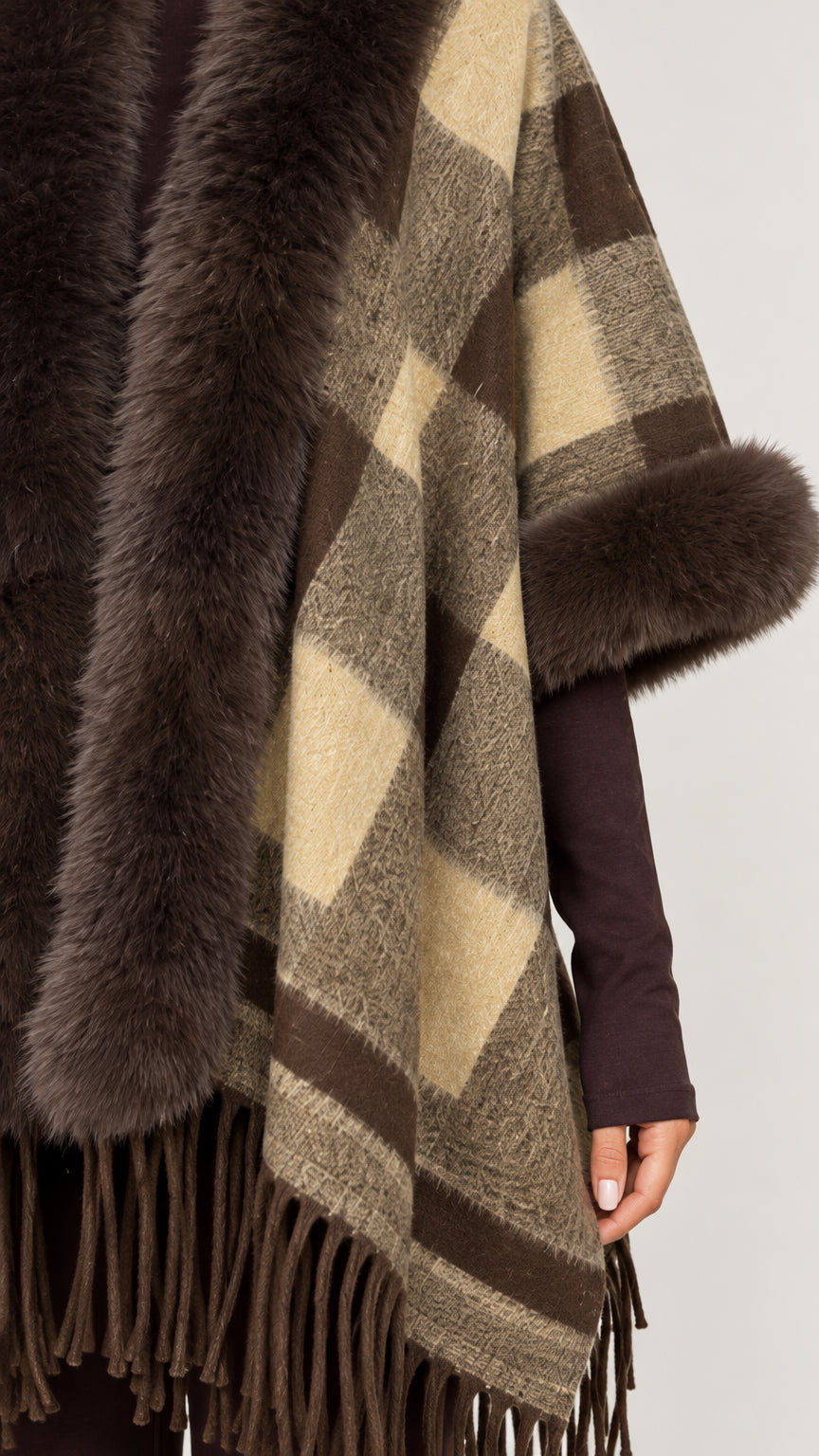 Close-up detail of soft plaid knit fabric and faux fur trim