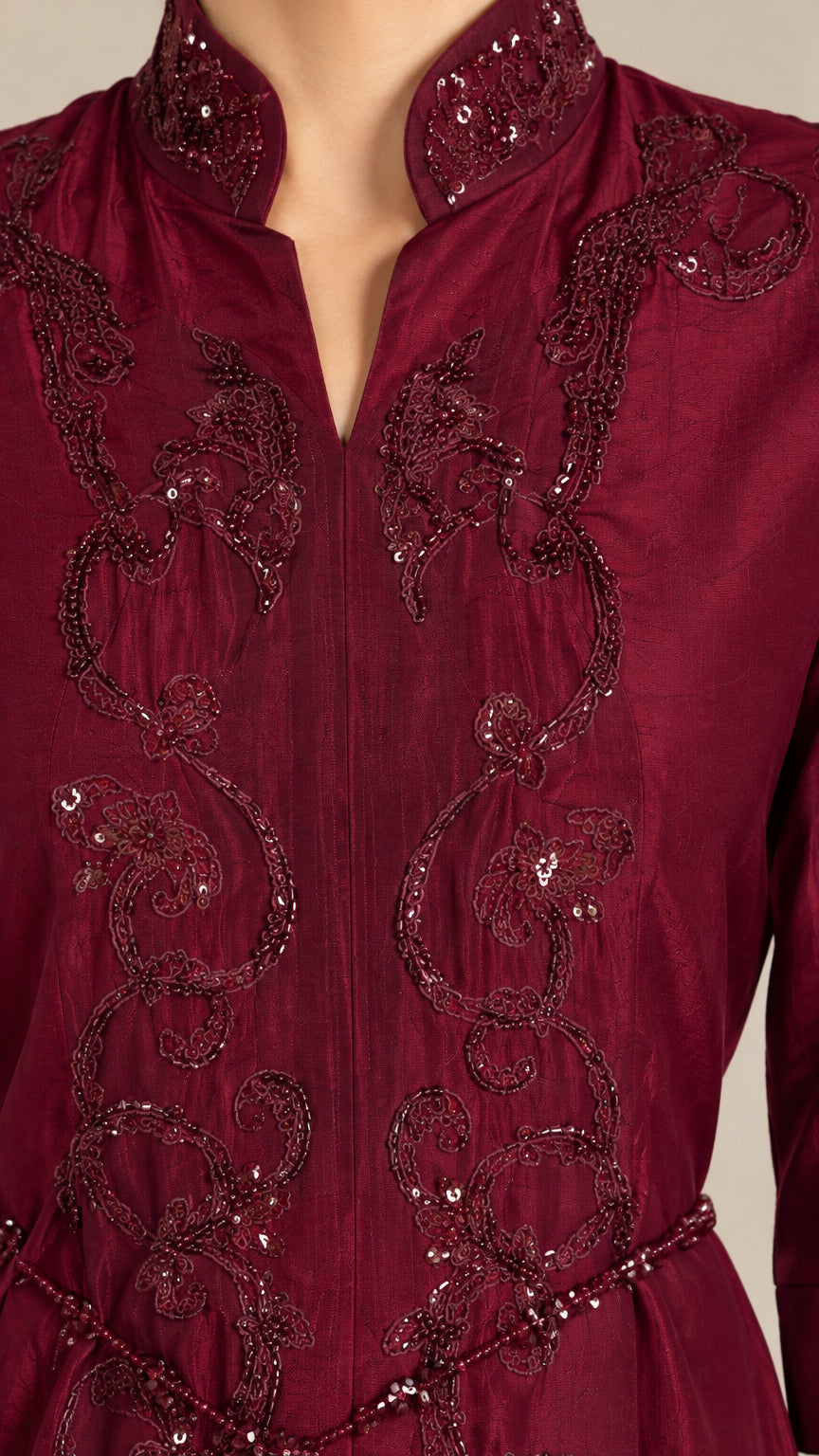 Close-up detail of burgundy notched Mandarin neckline with intricate beadwork and embroidery