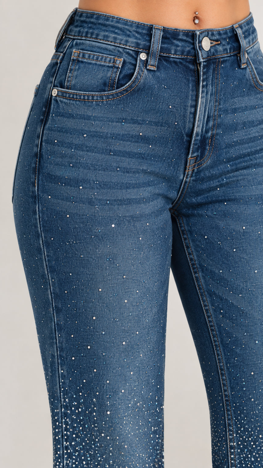 Close-up detail of rhinestone embellishments and pocket stitching on blue denim