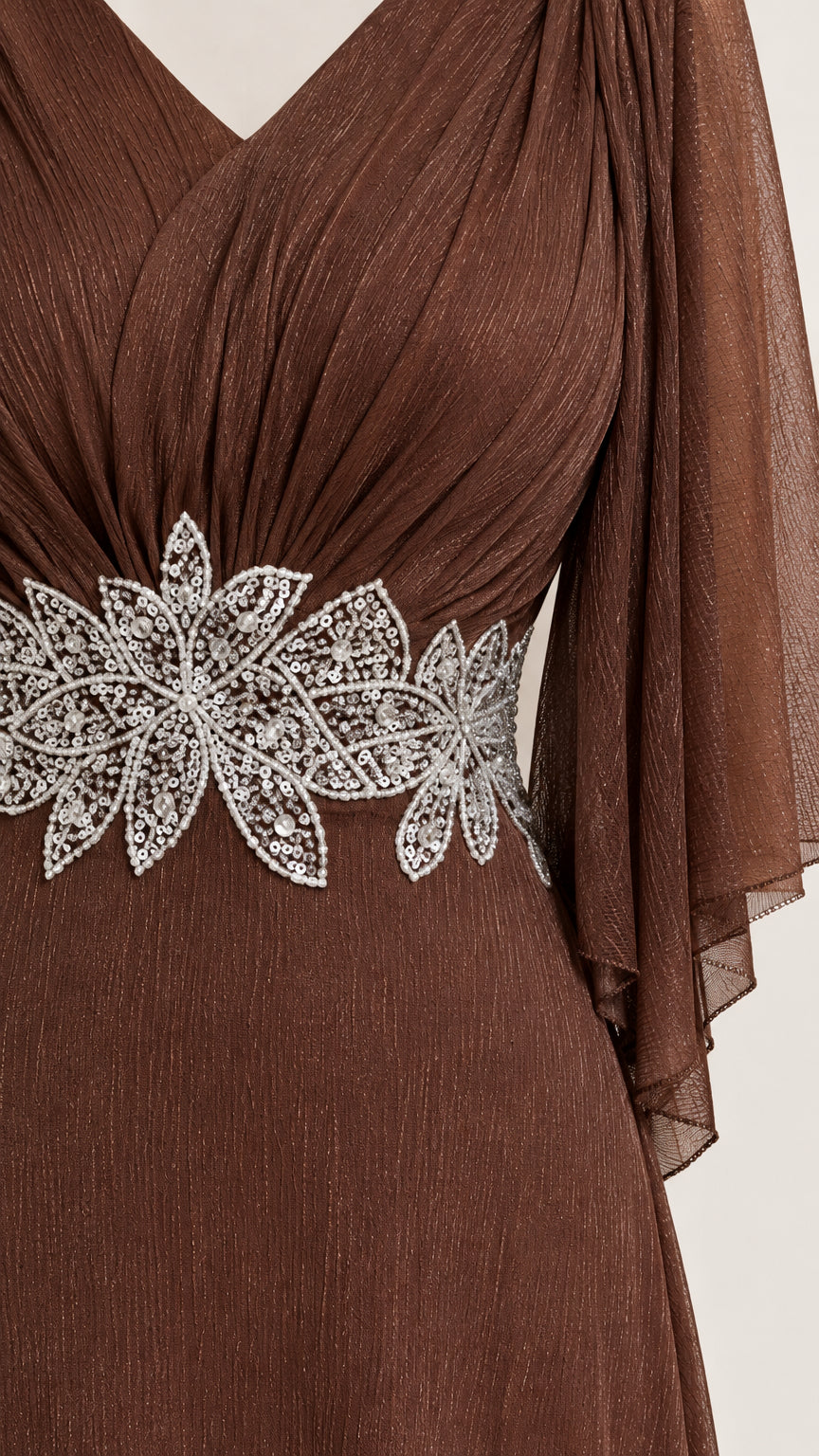 Close-up detail of pleated bodice and floral sequin embroidered waist applique