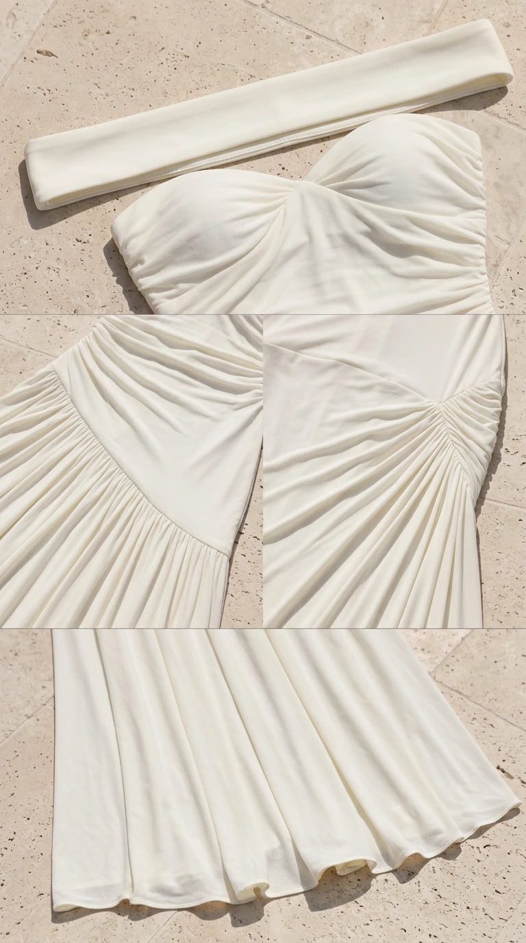 Close-up detail of sweetheart neckline, ruching, and pleated skirt texture in ivory