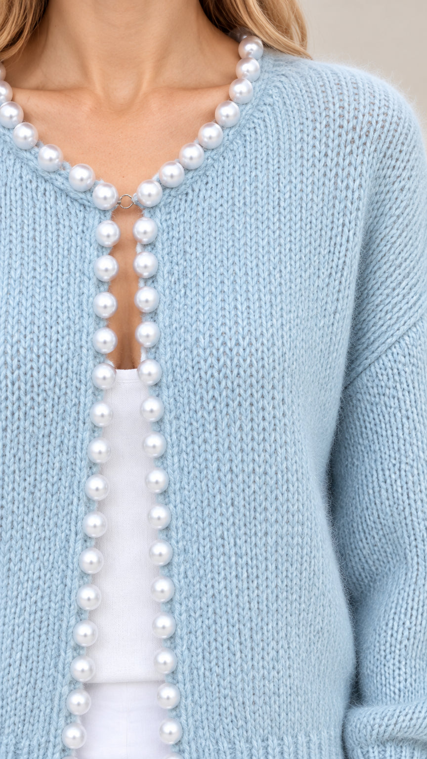 Close-up detail of faux pearl bead trim on Light Blue knit cardigan