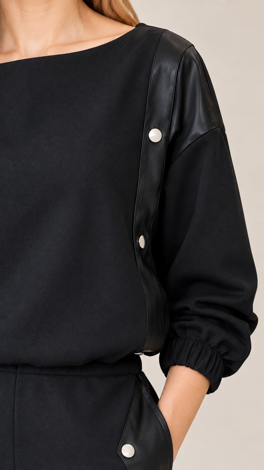 Close-up detail of boat neckline and contrast shoulder panel with snap buttons