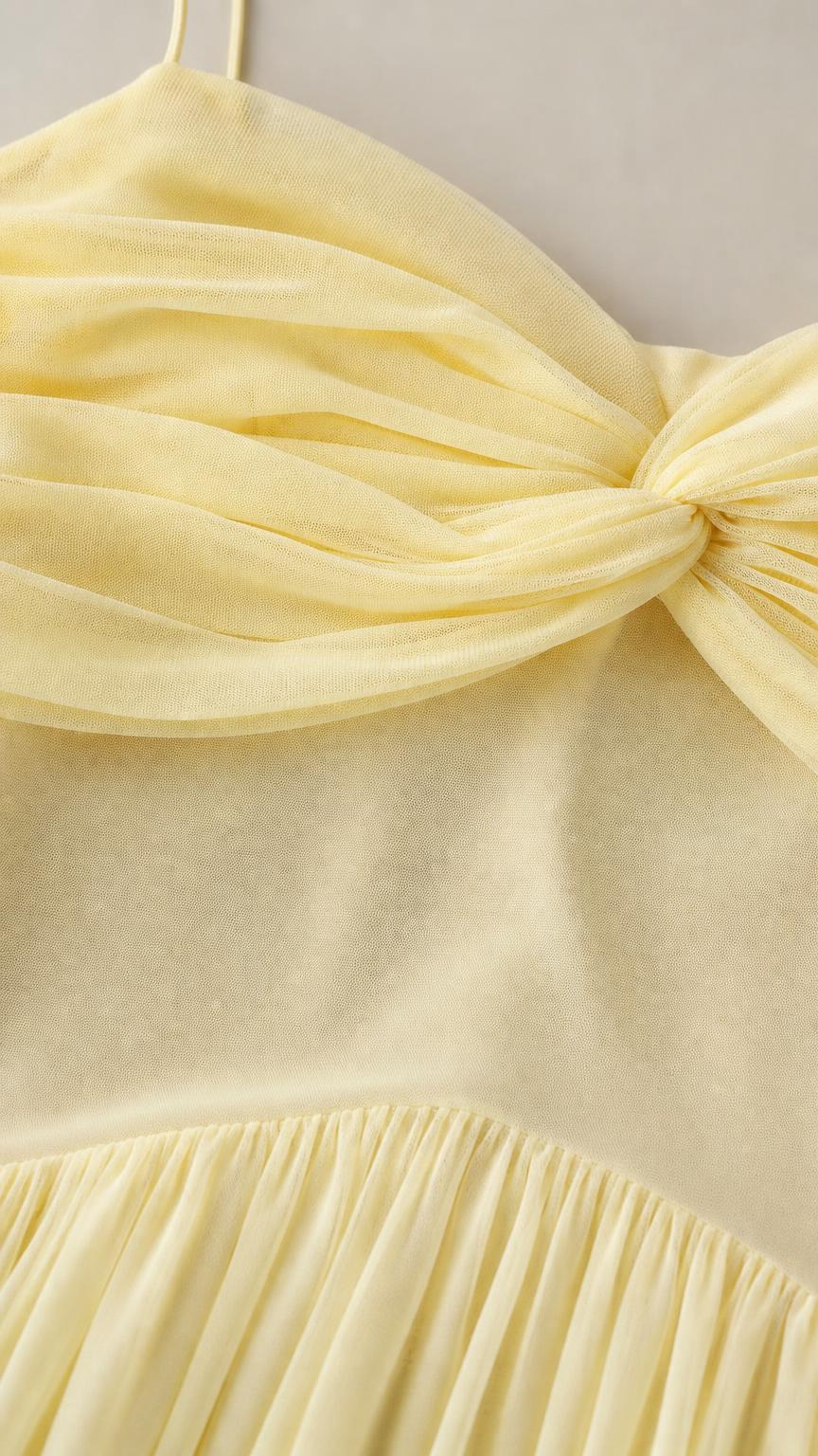 Close-up detail of bodice ruching and pleating on chiffon dress