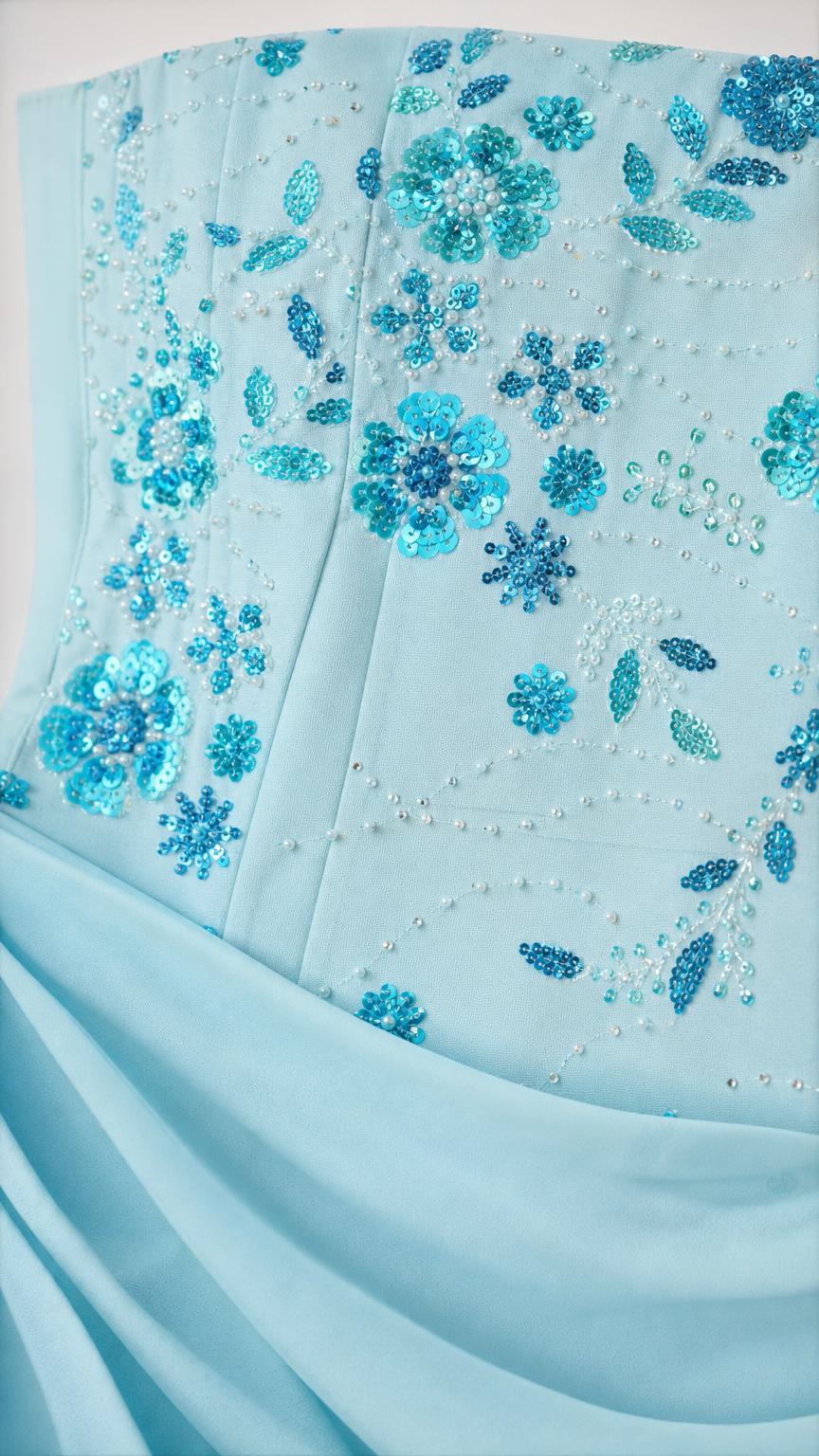 Close-up of floral sequin and bead embroidery on light blue fabric