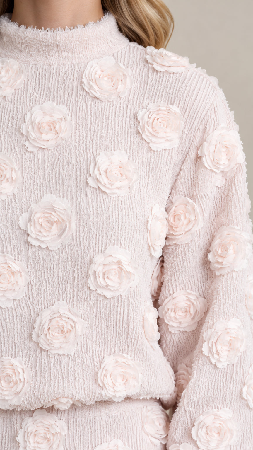 Close-up detail of textured crinkle fabric and 3D floral rosette embellishments in Blush Pink