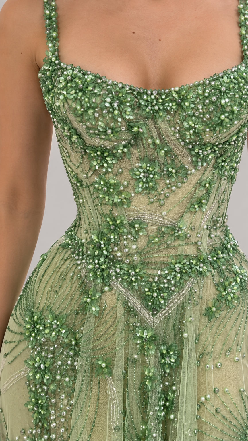 Close-up detail of green beaded embroidery and scoop neckline on bodice