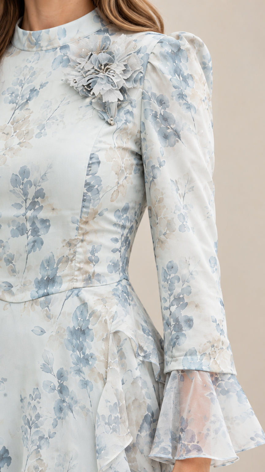 Close-up detail of mock neckline with 3D fabric flower and flared bell sleeve cuff