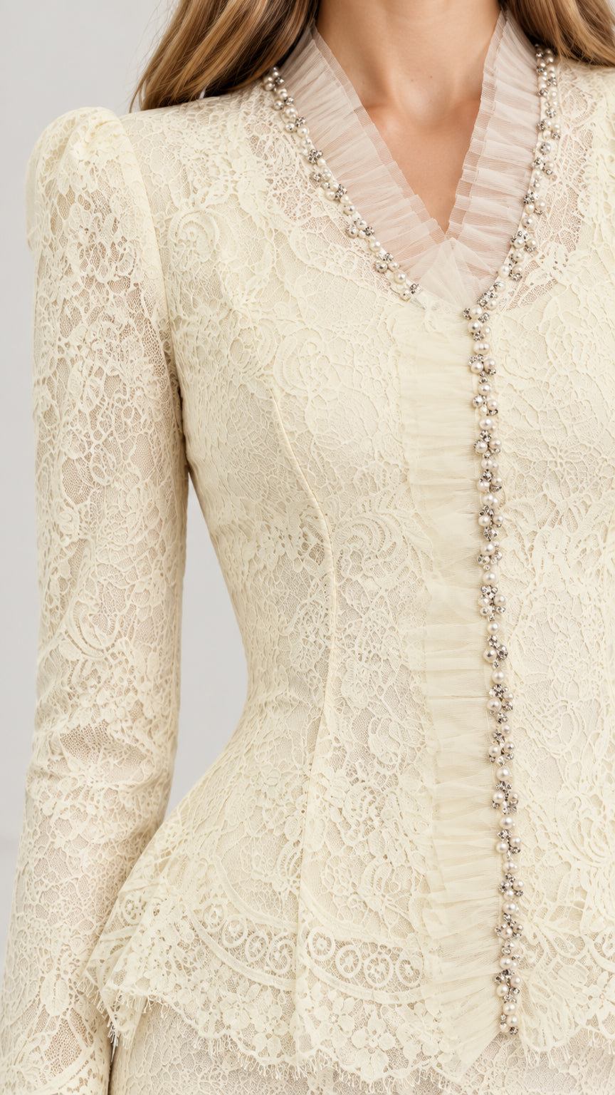 Close-up of beaded V-neckline and decorative buttons on Ivory lace jacket