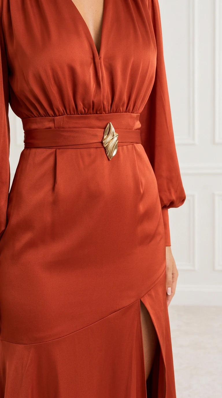 Close-up of rust satin gown bodice, gathered waistband with metallic buckle, and front slit
