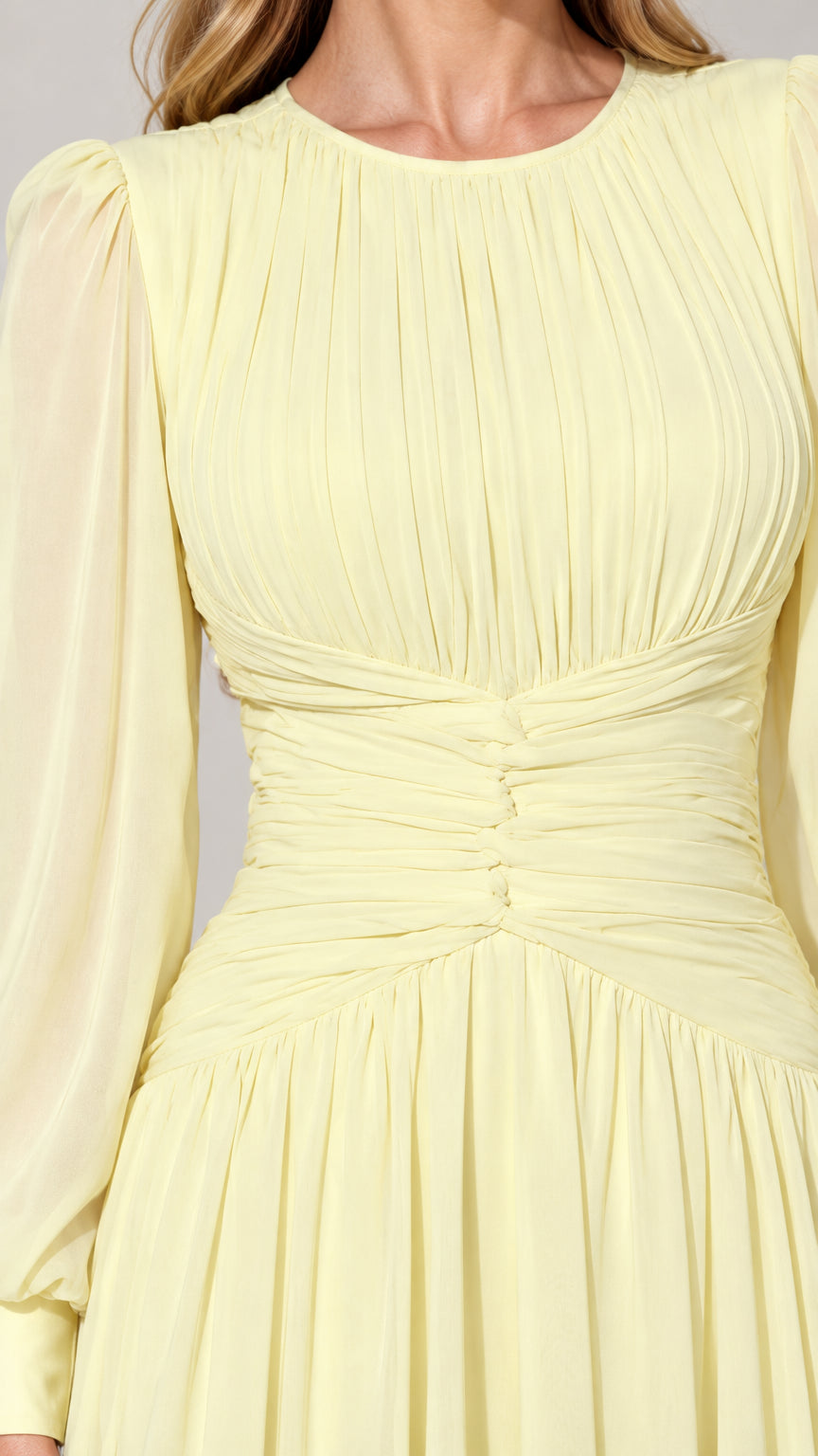 Close-up detail of pleated bodice and ruched waist on pale yellow dress