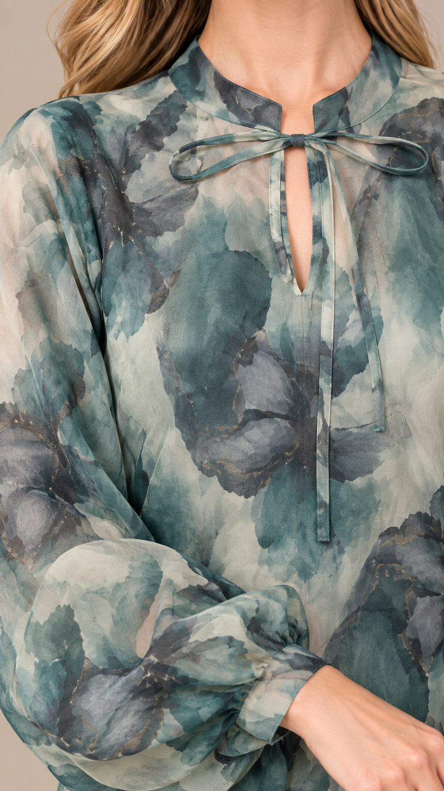 Close-up detail of keyhole tie neckline and balloon sleeve cuff on floral maxi dress