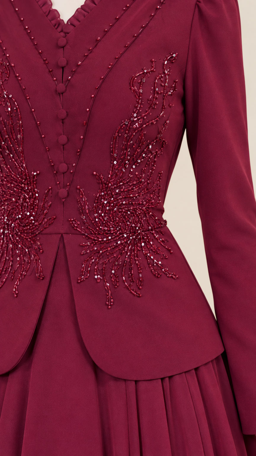 Close-up of intricate beaded and sequined embroidery on buttoned bodice