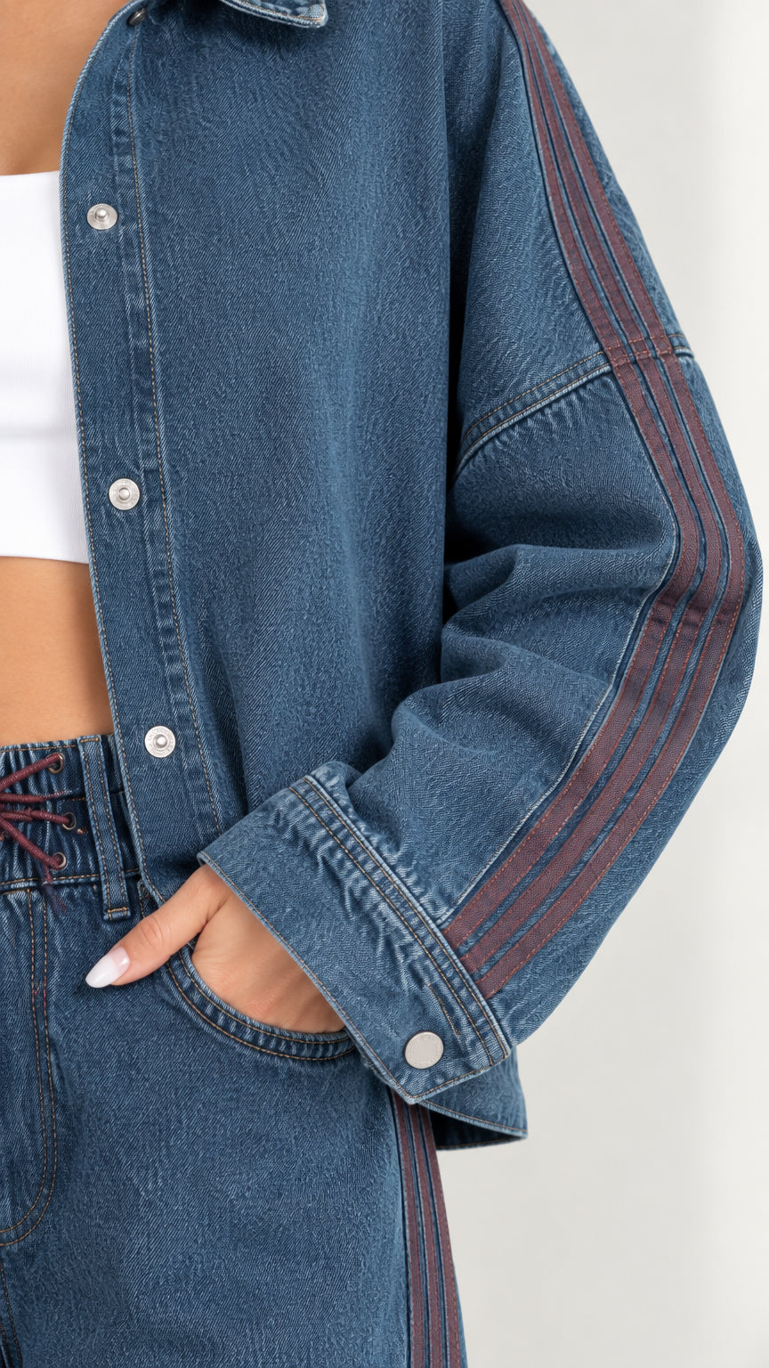 Close-up detail of jacket sleeve and pocket with contrast side stripe in Classic Blue