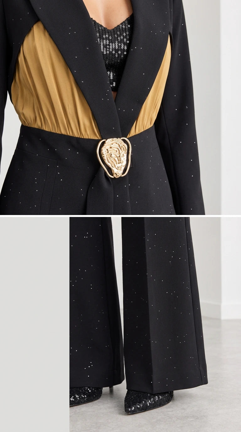Close-up detail of ornate gold-tone waist buckle, contrast pleating, and trousers