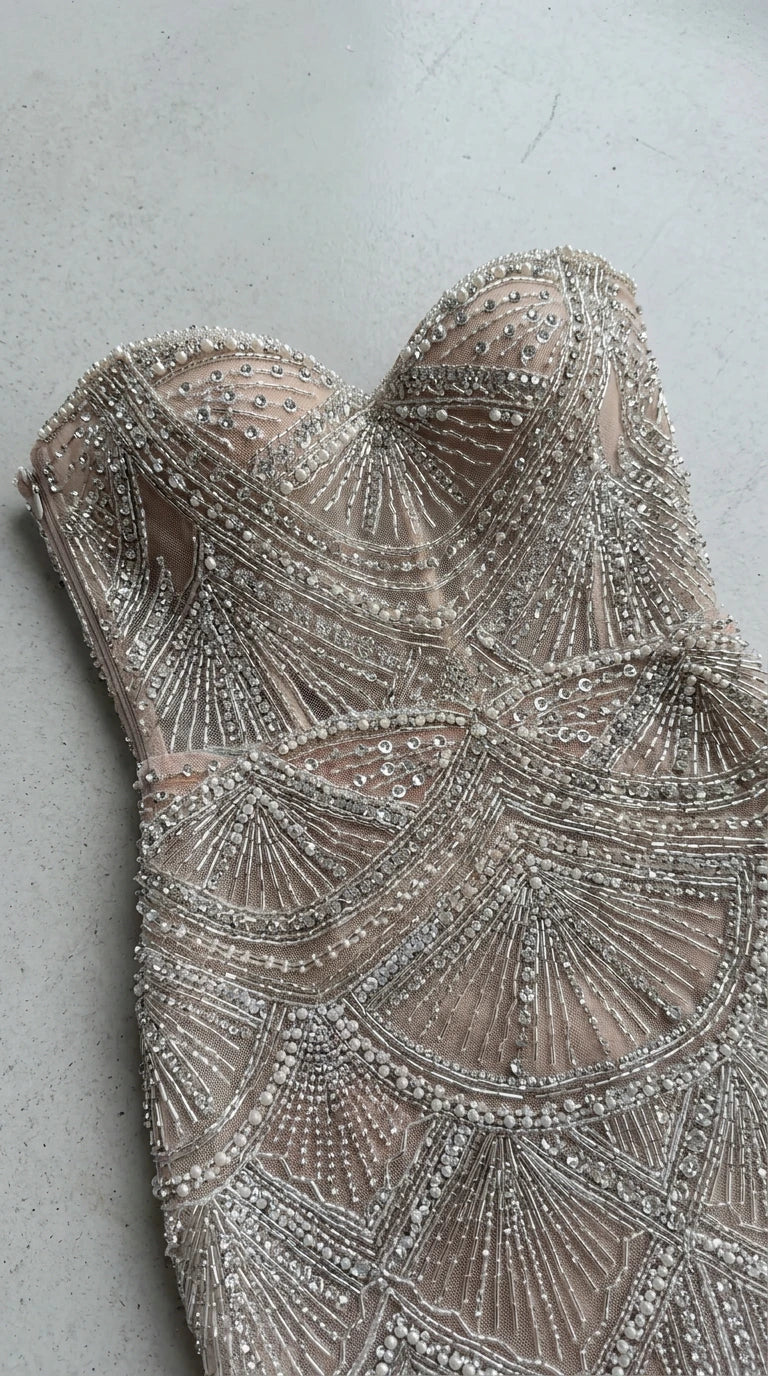 Close-up detail of intricate beading and sweetheart neckline on champagne gown
