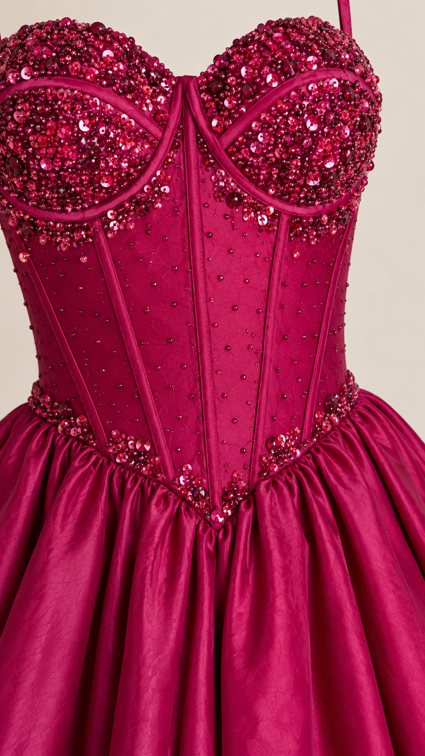 Close-up of magenta sweetheart bodice with intricate beading and corset boning
