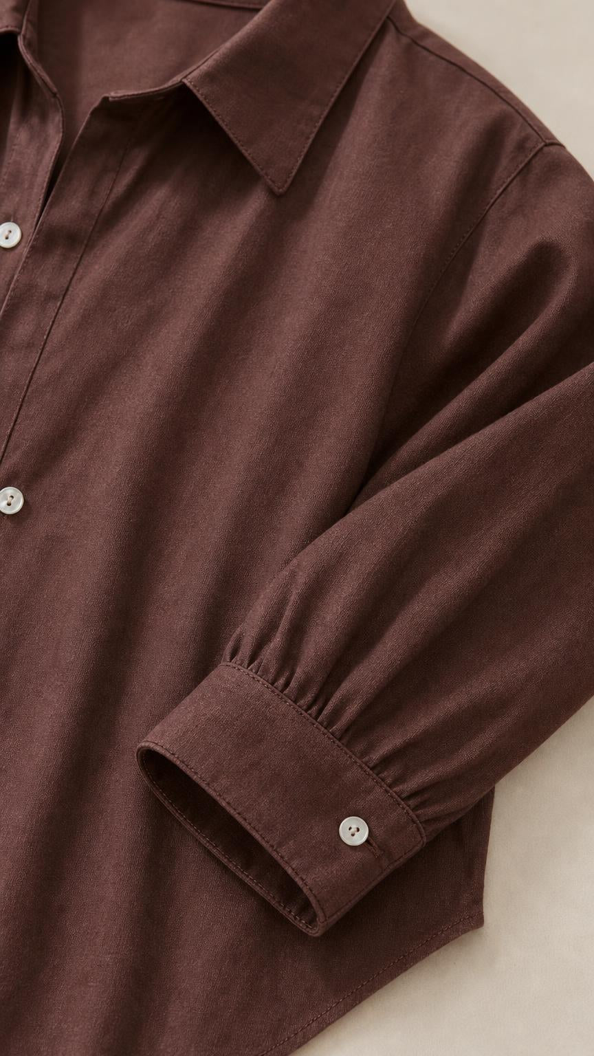 Close-up of brown shirt collar, button placket, and sleeve cuff detail