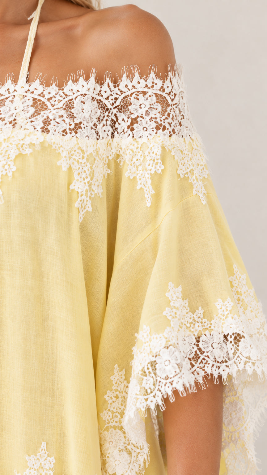 Close-up detail of sheer woven fabric and intricate floral crochet lace trim
