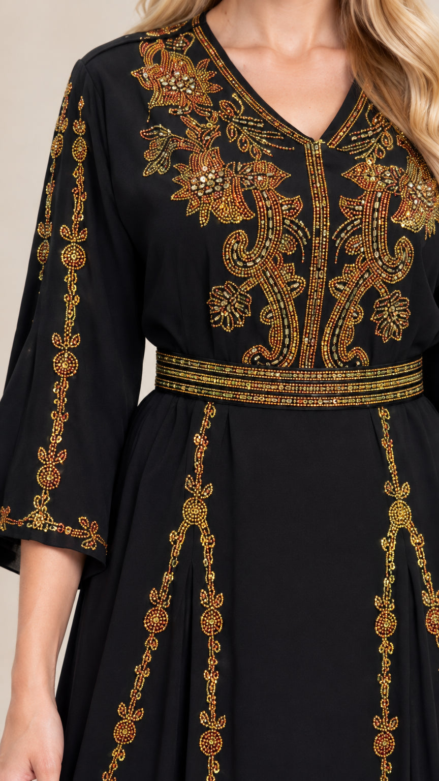 Close-up of intricate gold embroidery on black V-neck bodice and waist