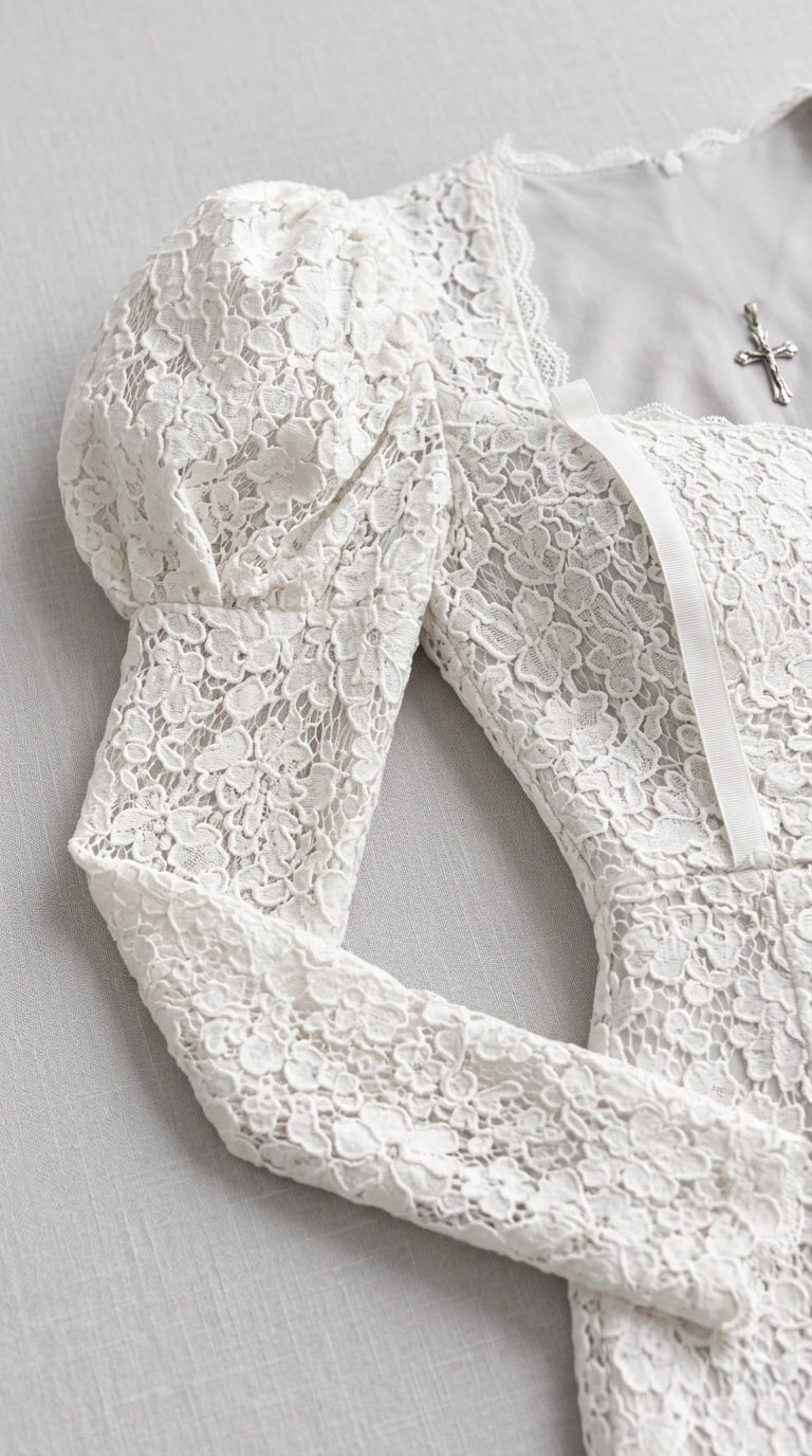Close-up detail of white floral lace fabric and puff shoulder design