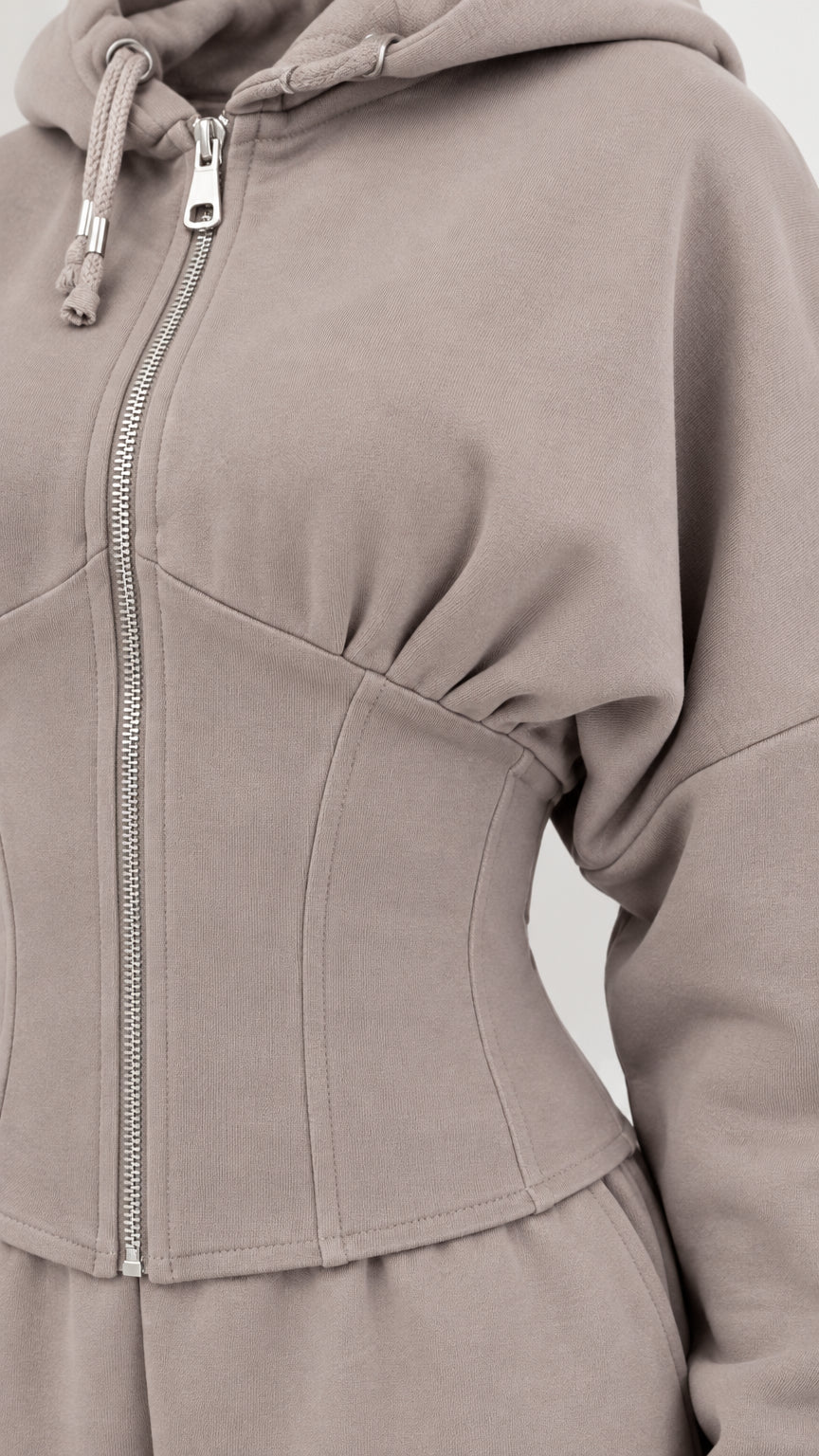 Close-up detail of taupe corset seaming and front zipper on hoodie