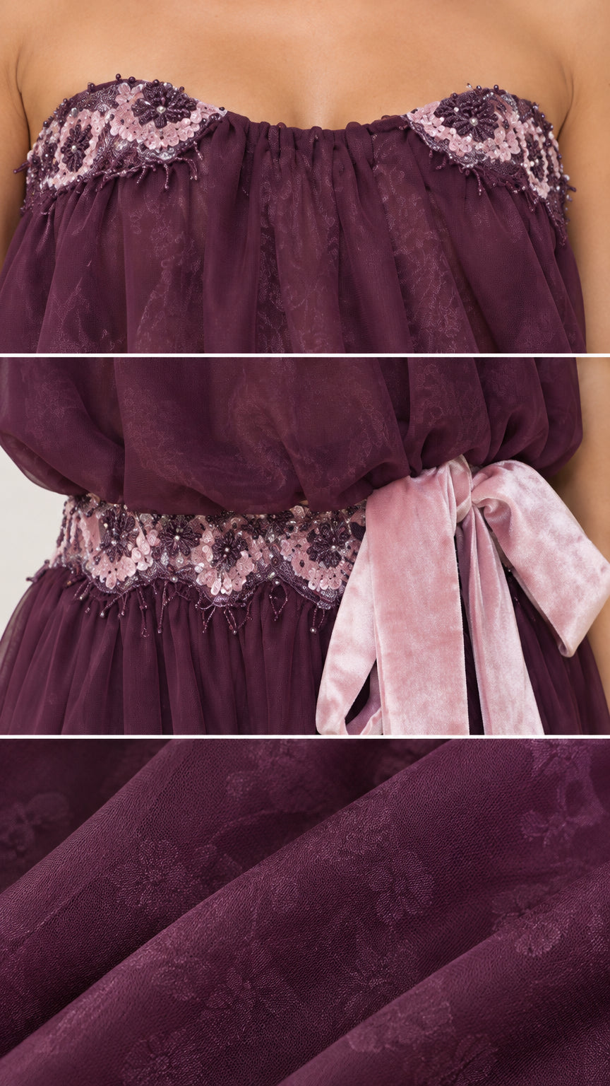 Close-up details of lace neckline, waist trim, and ribbon sash on Plum gown