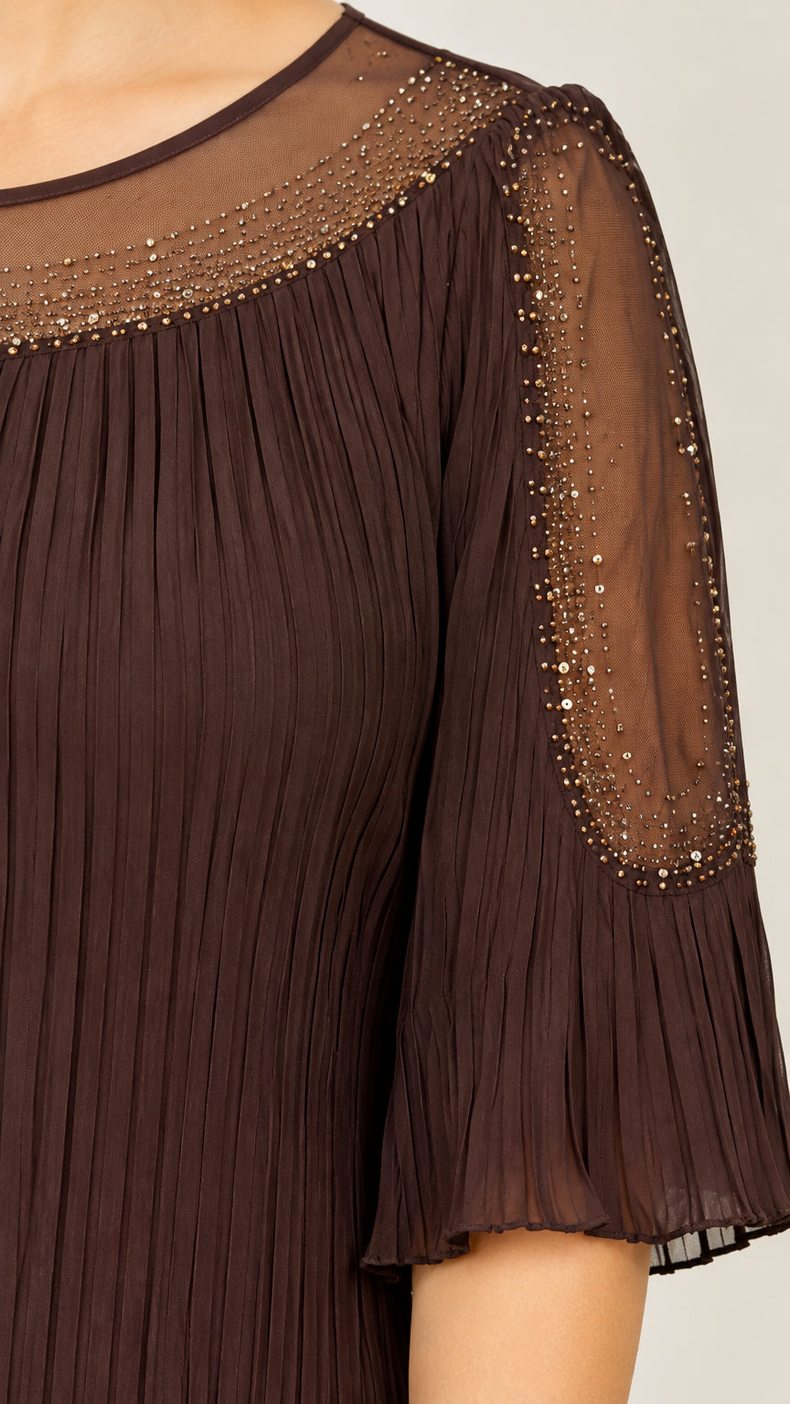 Close-up detail of sheer mesh yoke, sparkling rhinestone embellishments, and pleated neckline