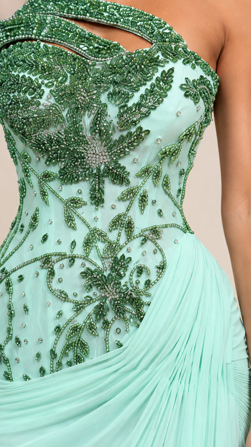 Close-up detail of green botanical beadwork and cutout on mint bodice