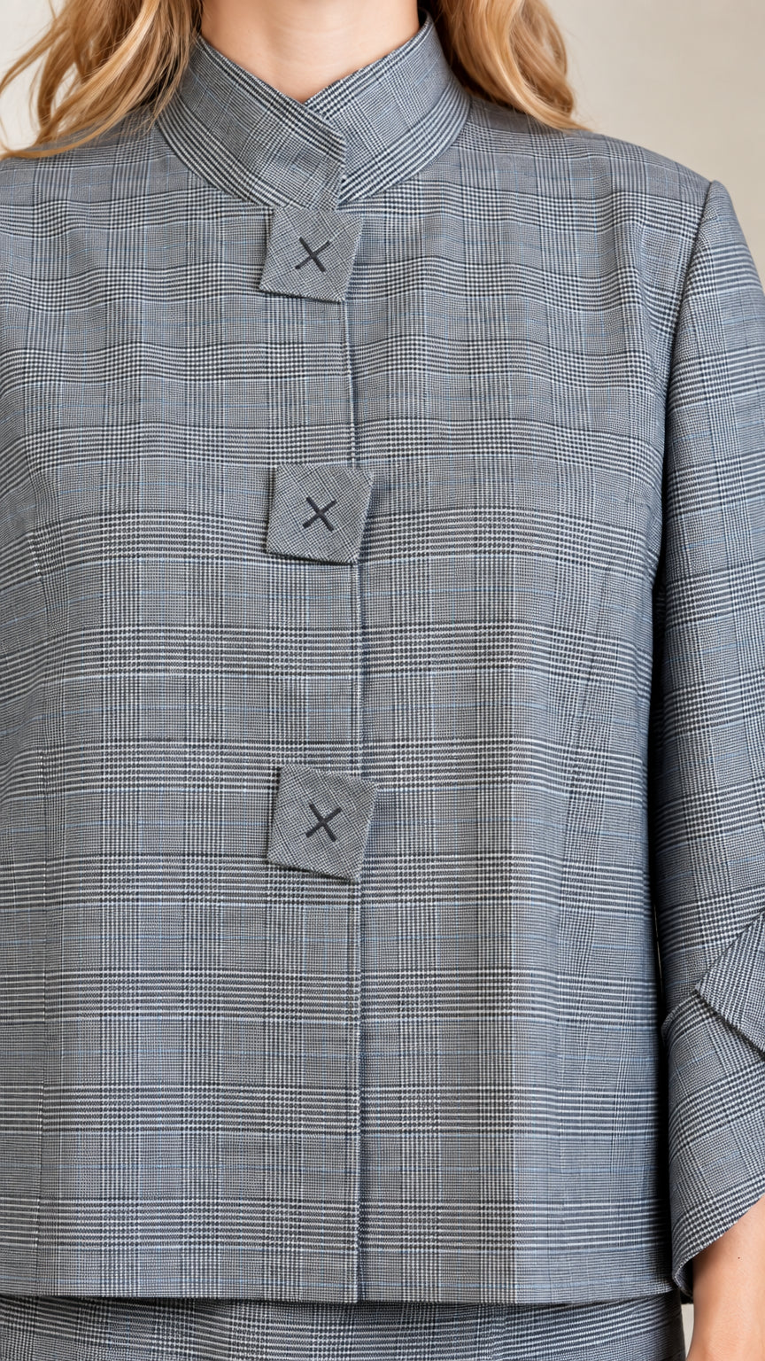Close-up detail of geometric square buttons and plaid texture