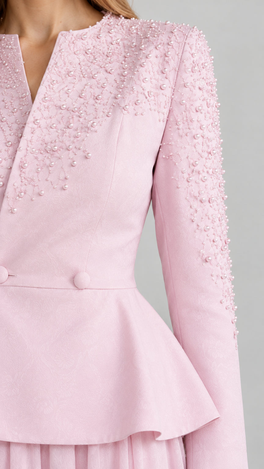 Close-up of pearl bead embellishment on Blush Pink peplum top shoulder and neckline
