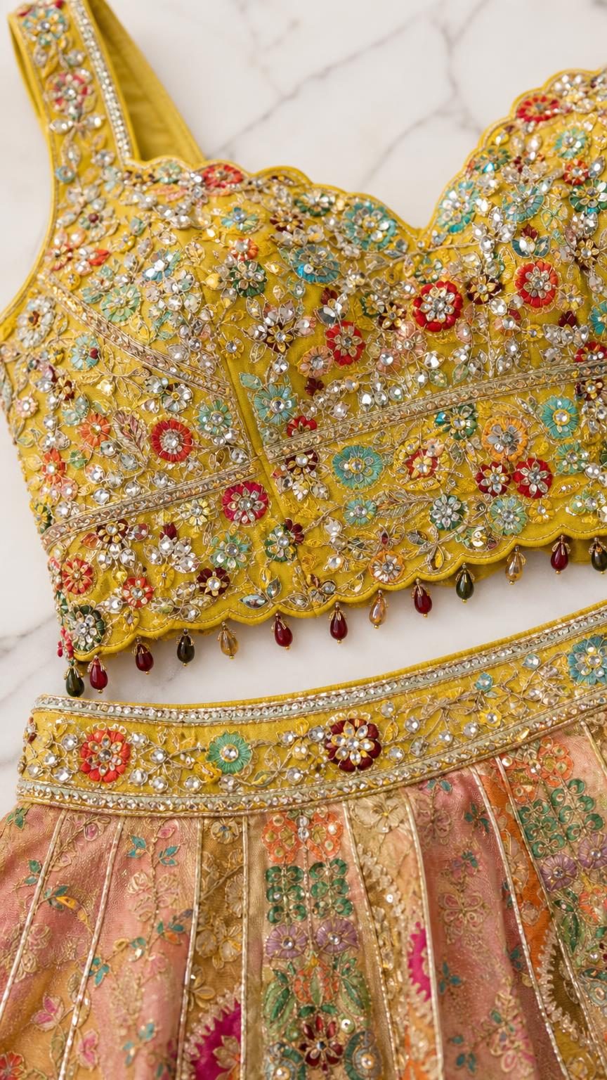 Close-up detail of the heavily embellished yellow blouse and skirt waistband