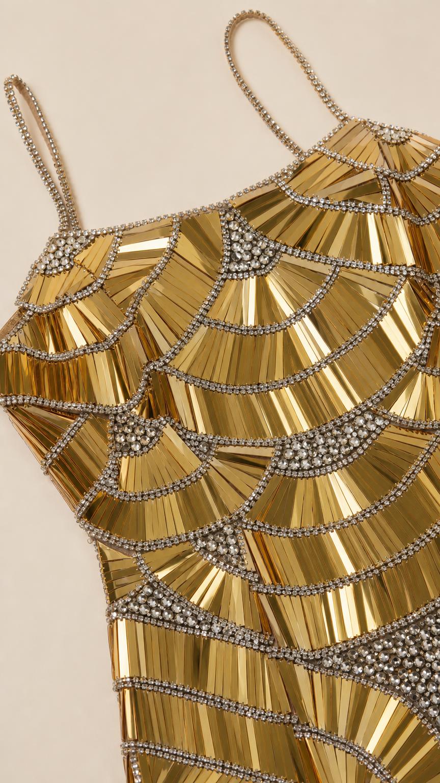 Close-up detail of geometric beadwork and spaghetti straps on gold gown