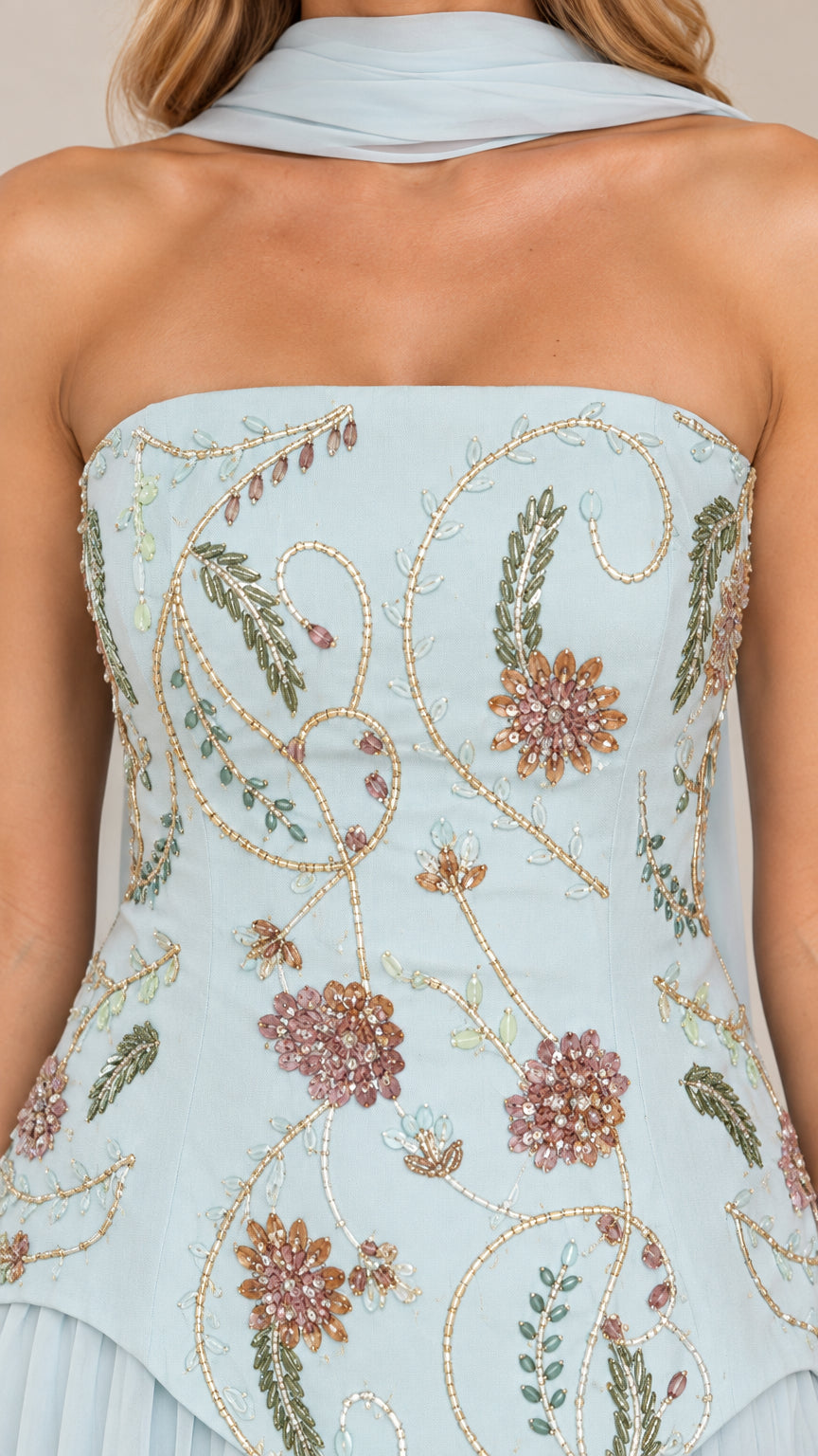 Close-up of sky blue strapless bodice with floral embroidery and beadwork