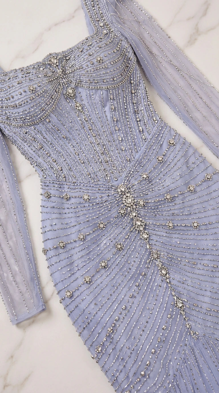 Close-up of intricate silver beadwork and ruched mesh detail on gown bodice