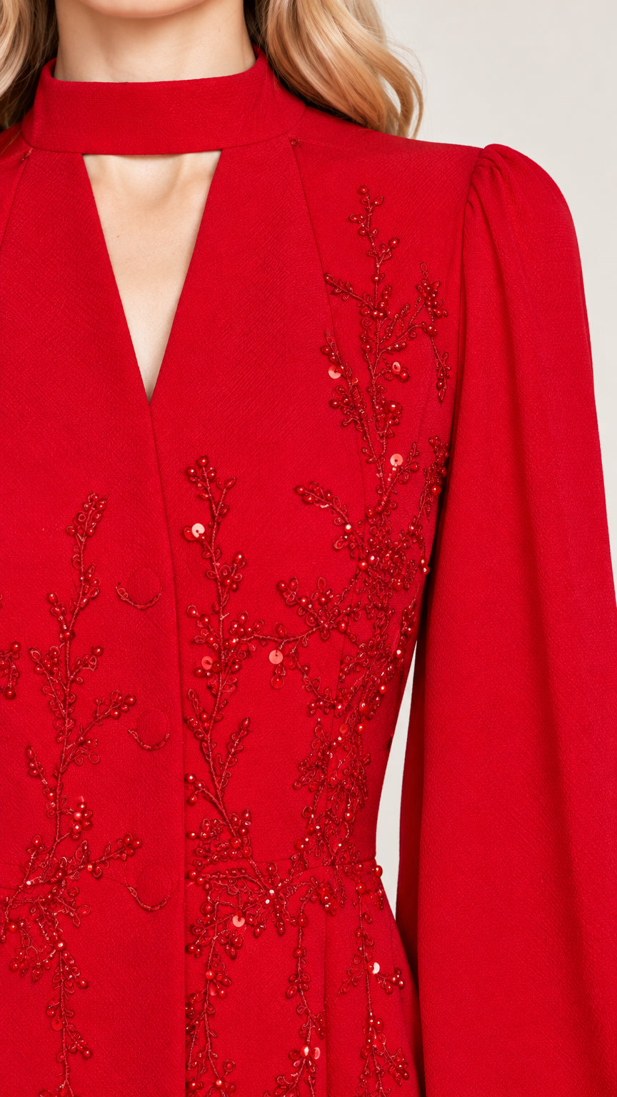 Close-up of red beaded floral embroidery and cutout choker neckline
